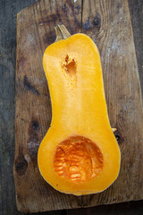 juicy ripe orange pumpkin on a wooden background