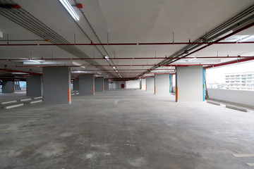 Obraz premium Parking lot on the parking building at Bangkok, Thailand. Parking space on the tall building with Electrical wiring and fire hose.