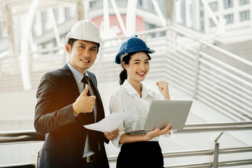 Asian engineer chief consult with secretary. Quality engineers or construction teamwork. Safety concern for engineering or building work site or plant. Wearing helmet and protective equipment can safe