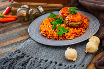 stuffed tomatoes with rice on a white plate