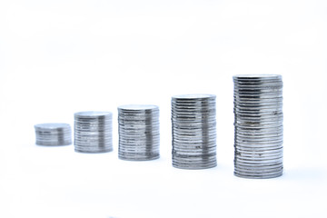 pile of silver coins stack and growing money graph on rows, isolated on white background with clip path. Income, profits, finance, Investment, Interest and Saving money concept, indonesia rupiah.,