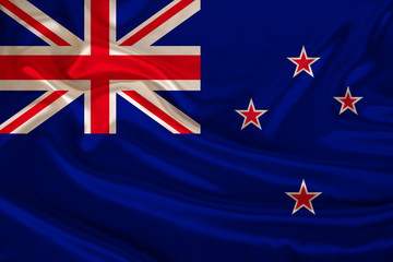 photo of the New Zealand state national flag on a luxurious texture of satin, silk with waves, folds and highlights, close-up, copy space, illustration