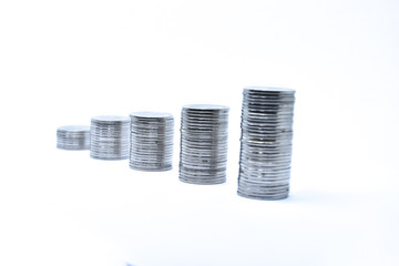 pile of silver coins stack and growing money graph on rows, isolated on white background with clip path. Income, profits, finance, Investment, Interest and Saving money concept, indonesia rupiah.,