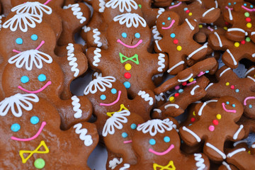 gingerbread cookie.Gingerbread men with candy cane laying on brown wood background. Christmas or New Year composition. Top view.
