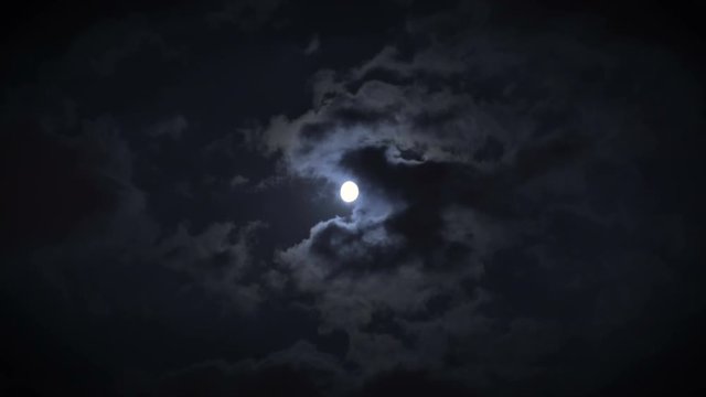 Night sky with clouds glowing from full moon