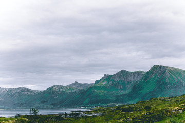 Photo of sea, hills, cloudy sky at Norway.