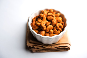 Masala Kaju or spicy Cashew in a bowl. Popular festival snack from India/asia, also known as Chakna...