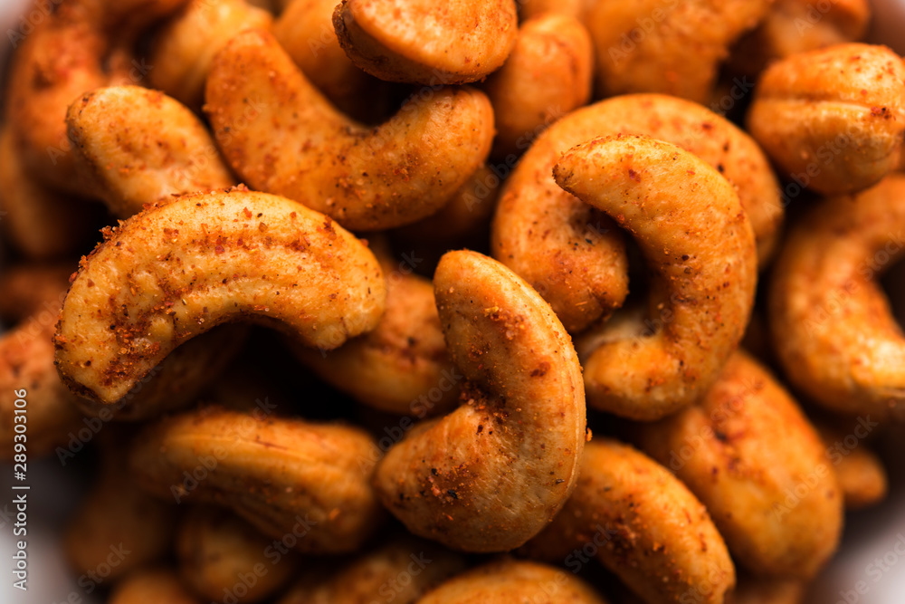 Wall mural Masala Kaju or spicy Cashew in a bowl. Popular festival snack from India/asia, also known as Chakna recipe