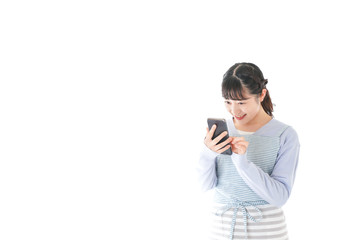 笑顔でスマートフォンを使う若い主婦