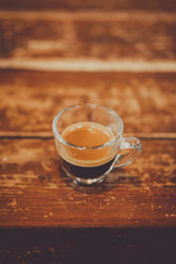 Espresso shot on wood table in cafe shop.