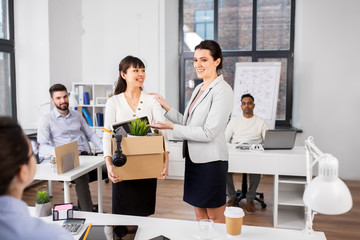 business, new job and corporate concept - female employee with personal stuff meeting colleagues at office