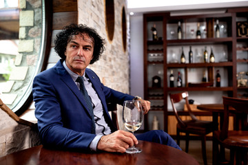 Businessman in blue suit sitting at the table