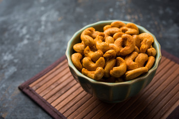 Masala Kaju or spicy Cashew in a bowl. Popular festival snack from India/asia, also known as Chakna recipe