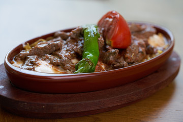 Meatballs with tomato sauce and yogurt in a pan