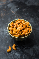 Masala Kaju or spicy Cashew in a bowl. Popular festival snack from India/asia, also known as Chakna recipe