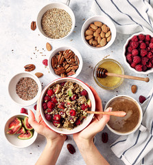 Ingredients for a healthy breakfast, oatmeal with raspberries, figs, pecans, almonds, flax seeds, chia seeds with honey and coffee. Good morning, health concept. Top view
