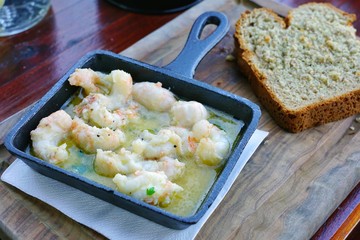 Dish of sautéed prawns in Irish butter in a cast iron pan in Howth, Ireland