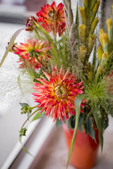  Bouquet of dahlias and gladioli in a vase on the window, сlose-up
