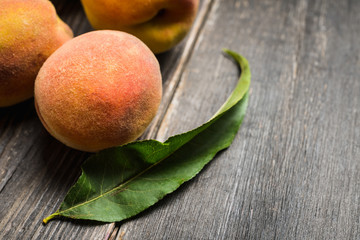 Sweet ripe peaches on the rustic background. Selective focus. Shallow depth of field.
