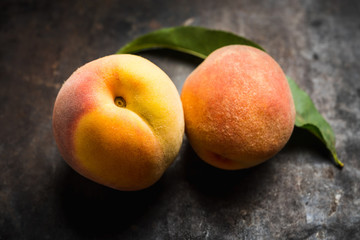 Sweet ripe peaches on the rustic background. Selective focus. Shallow depth of field.