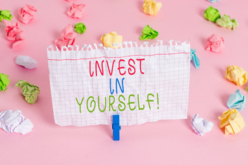 Conceptual hand writing showing Invest In Yourself. Concept meaning learn new things or materials thus making your lot better Colored crumpled papers empty reminder pink floor clothespin