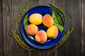 Sweet ripe peaches on the rustic background. Selective focus. Shallow depth of field.