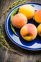 Sweet ripe peaches on the rustic background. Selective focus. Shallow depth of field.