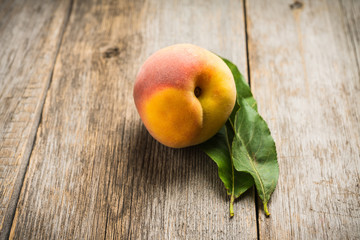 Sweet ripe peaches on the rustic background. Selective focus. Shallow depth of field.