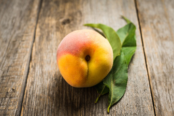 Sweet ripe peaches on the rustic background. Selective focus. Shallow depth of field.