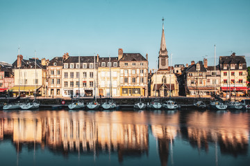 Fototapeta na wymiar HONFLEUR, FRANCE - MAY4, 2018:Waterfront reflection of traditional houses in Honfleur, Normandy, France