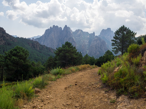 Mountain path with the Aiguilles de Bavella in the background (Corsica - France)