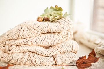 Fototapeta na wymiar Knitted wool sweaters. Pile of knitted winter, autumn clothes knitwear.