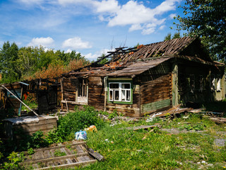 Destroyed wooden house green. House after fire