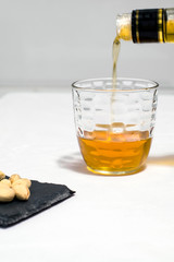 whiskey and pistachios in white background