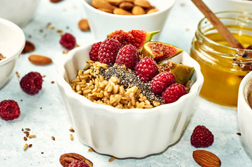 Oatmeal porridge with raspberry and figs in a bowl