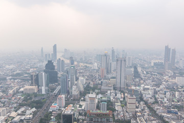 Fototapeta premium Air pollution in Bangkok with PM2.5 air-quality index (AQI) reached dangerous level with dust and smog in hazy sky, threatening to public health, rooftop view