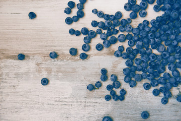 Blueberries on vintage style background. Image is with selective focus. Top view