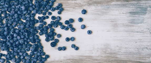 Blueberries on vintage style background. Image is with selective focus. Top view