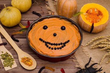 Pumpkin pie for Halloween with pumpkins, decorated with sweets