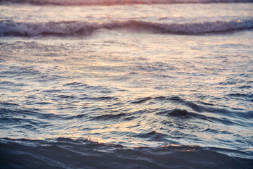 Small sea waves in sunrise on a Mallorca beach