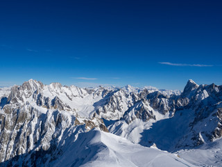 France, january 2018: View on Chamonix Valley from top of Aiguille du Midi summit on a sunny winter day