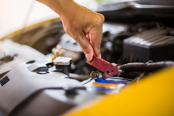 Check and maintenance the old battery in yellow car with yourself.