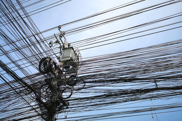 Tangle of Electrical cables and Communication wires on electric pole.