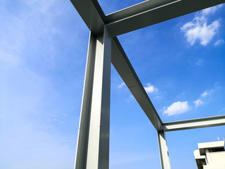 Structure of steel building construction with blue sky background.