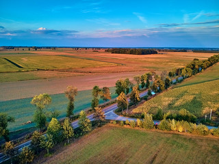 Beautiful panoramic aerial drone view to view of fields in eastern Poland at sunset, near Bialowieza Forest - near of the last and largest remaining parts of the immense primeval european forest
