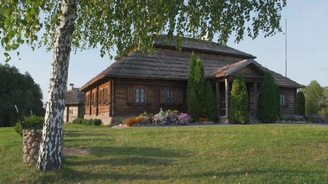 House on beautiful landscape - village of birthplace of Tadeusz Kosciuszko - Merechevshchina, near Kossovo city, Brest region, Belarus. Birch tree on foreground.