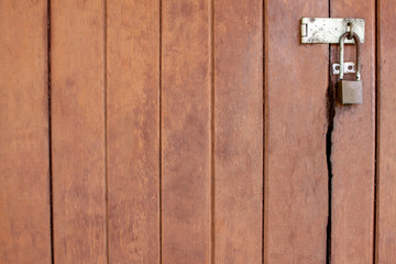 Old wood brown door with a key, door lock for safety