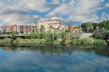 Fototapeta na wymiar View of Talavera de la Reina with the dome of the church of Santa Maria la Mayor reflected in the Tagus river. Toledo. Spain