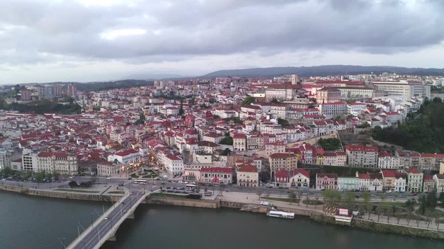 Aerial drone view of Coimbra city and Mondego river at sunset