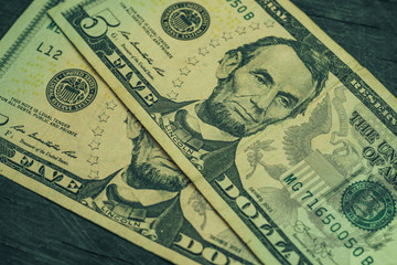 Lincoln's face in close up on a five dollar background. Five american, us dollars banknote.  Macro...